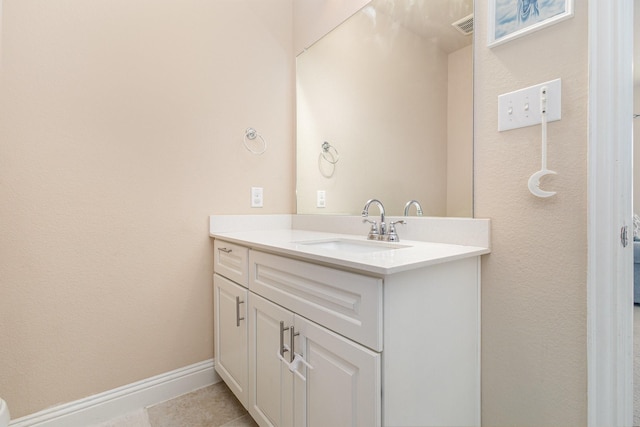 bathroom with vanity, tile patterned floors, and baseboards