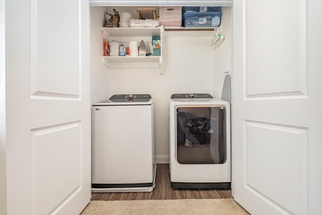 laundry room featuring wood finished floors and washer and dryer