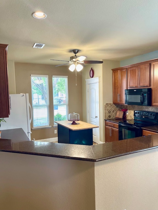 7125 Cotton Seed Dr, Mckinney, TX 75070 - kitchen with black appliances, tasteful backsplash, a ceiling fan, dark countertops, and brown cabinets