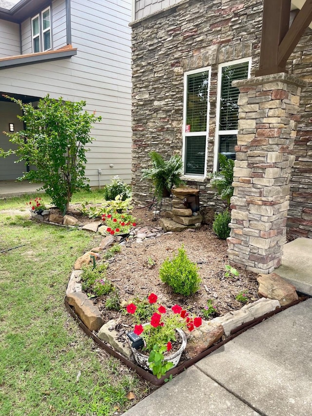 7125 Cotton Seed Dr, Mckinney, TX 75070 - view of exterior entry featuring stone siding and a lawn