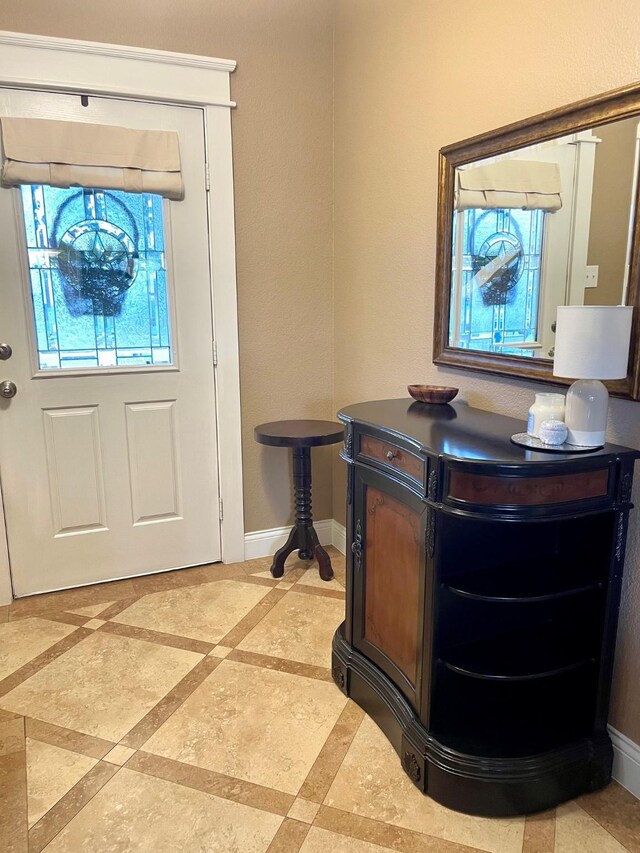 7125 Cotton Seed Dr, Mckinney, TX 75070 - foyer entrance featuring inlaid floor details and baseboards