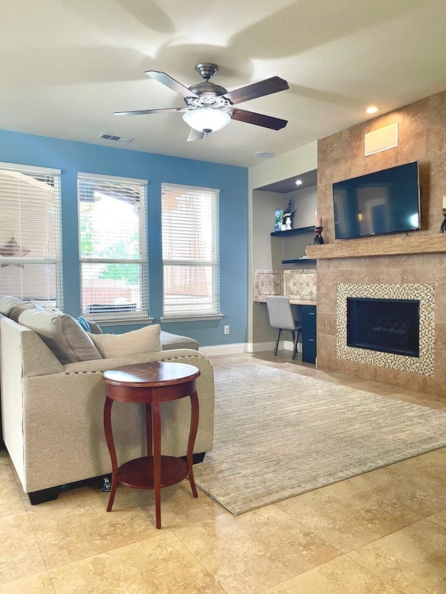 7125 Cotton Seed Dr, Mckinney, TX 75070 - living room with a ceiling fan, baseboards, and a tile fireplace