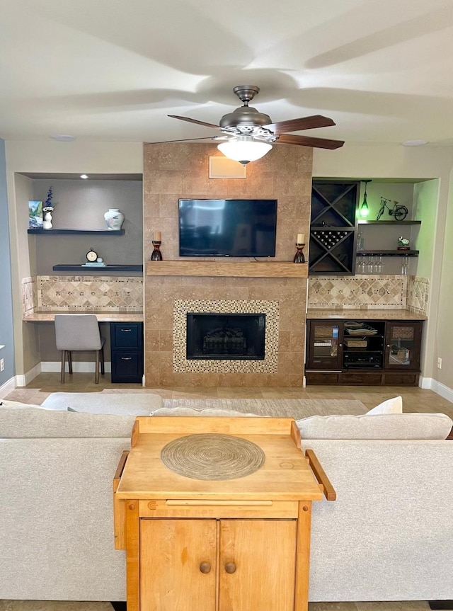 7125 Cotton Seed Dr, Mckinney, TX 75070 - living room featuring a fireplace, baseboards, and ceiling fan