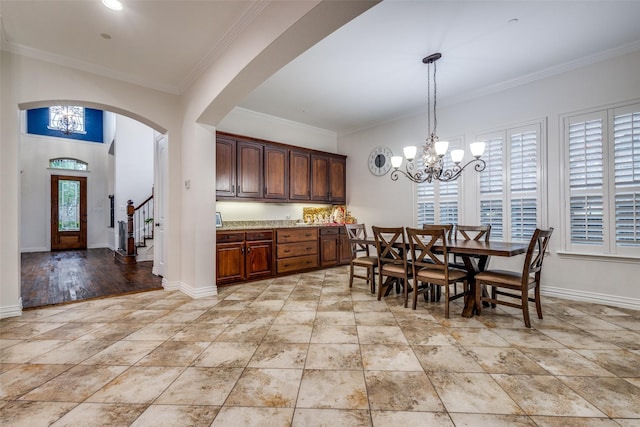 2204 Aberdeen Dr, Trophy Club, TX 76262 - dining area featuring a chandelier, crown molding, arched walkways, and baseboards