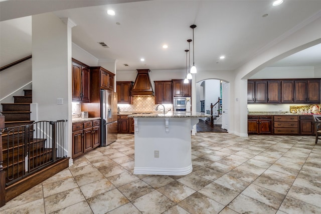 2204 Aberdeen Dr, Trophy Club, TX 76262 - kitchen with stainless steel fridge with ice dispenser, crown molding, custom range hood, decorative backsplash, and arched walkways
