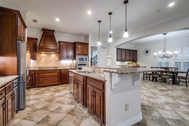 2204 Aberdeen Dr, Trophy Club, TX 76262 - kitchen featuring stainless steel appliances, premium range hood, ornamental molding, arched walkways, and a sink