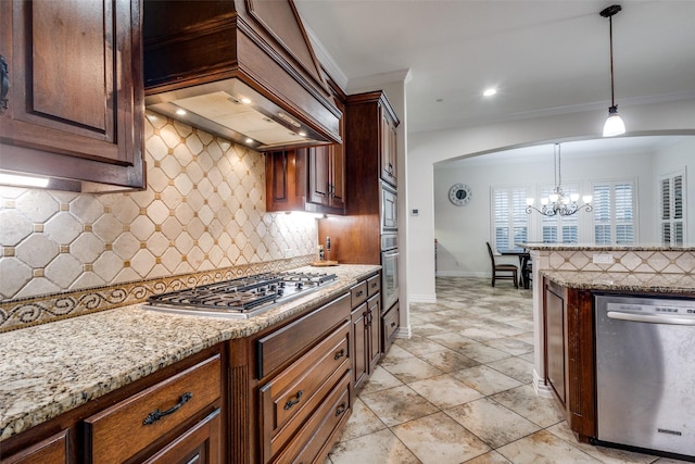 2204 Aberdeen Dr, Trophy Club, TX 76262 - kitchen with appliances with stainless steel finishes, a chandelier, custom range hood, light stone counters, and decorative backsplash