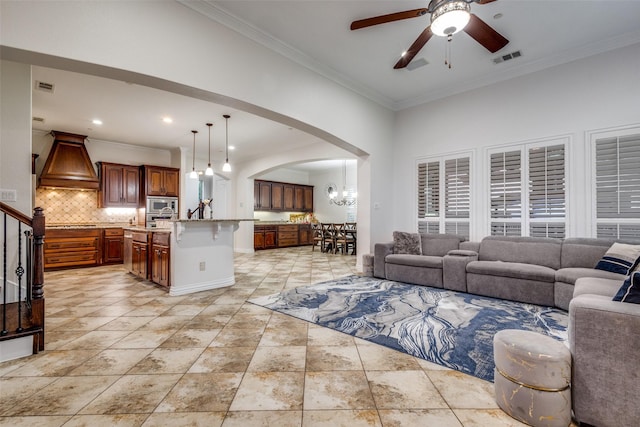 2204 Aberdeen Dr, Trophy Club, TX 76262 - living room featuring crown molding, a ceiling fan, arched walkways, stairs, and a chandelier