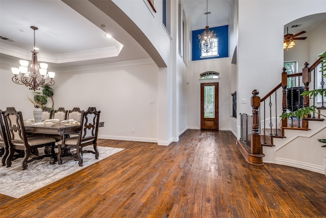 2204 Aberdeen Dr, Trophy Club, TX 76262 - foyer entrance with a chandelier, arched walkways, hardwood / wood-style floors, a ceiling fan, and crown molding