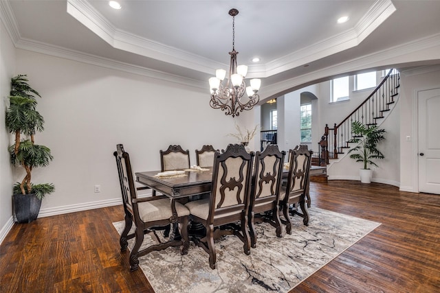 2204 Aberdeen Dr, Trophy Club, TX 76262 - dining space with a chandelier, wood finished floors, a tray ceiling, stairs, and arched walkways