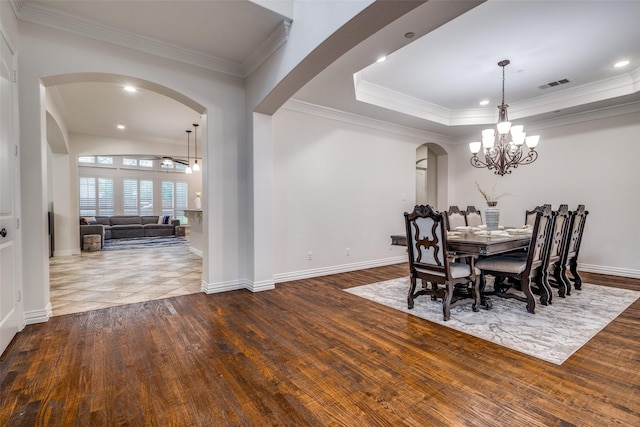 2204 Aberdeen Dr, Trophy Club, TX 76262 - dining room featuring arched walkways, dark wood-style flooring, a chandelier, crown molding, and baseboards