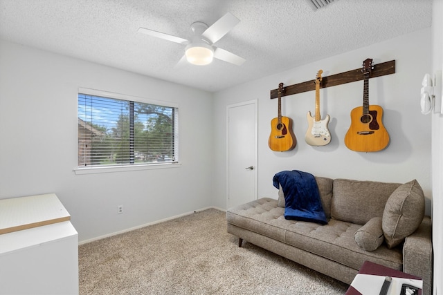 living area featuring carpet floors, a ceiling fan, a textured ceiling, and baseboards