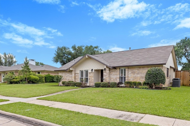 ranch-style house with a front yard, central air condition unit, brick siding, and a shingled roof