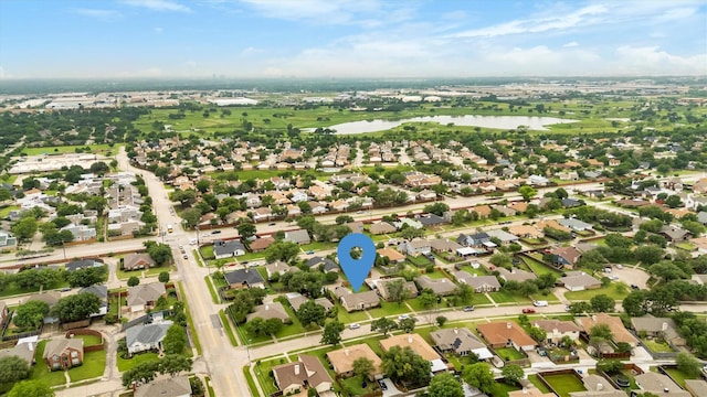 aerial view of property's location with a large body of water and nearby suburban area