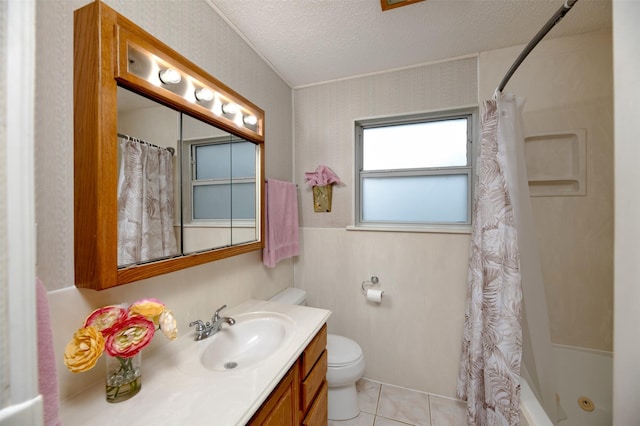 bathroom featuring toilet, vanity, a textured ceiling, tile patterned floors, and shower / bath combo