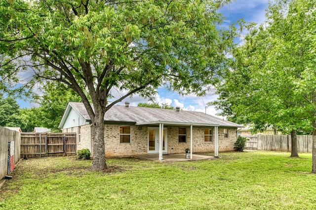 rear view of property with a patio and brick siding