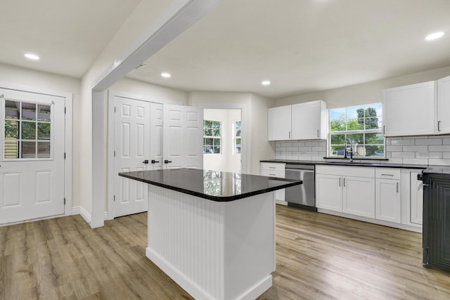 1110 Green St, Abilene, TX 79603 - kitchen with dishwasher, a sink, backsplash, dark countertops, and recessed lighting