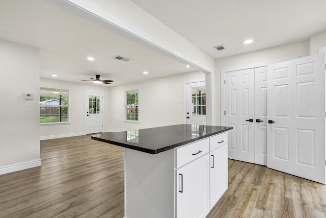 1110 Green St, Abilene, TX 79603 - kitchen with light wood finished floors, recessed lighting, white cabinets, open floor plan, and baseboards