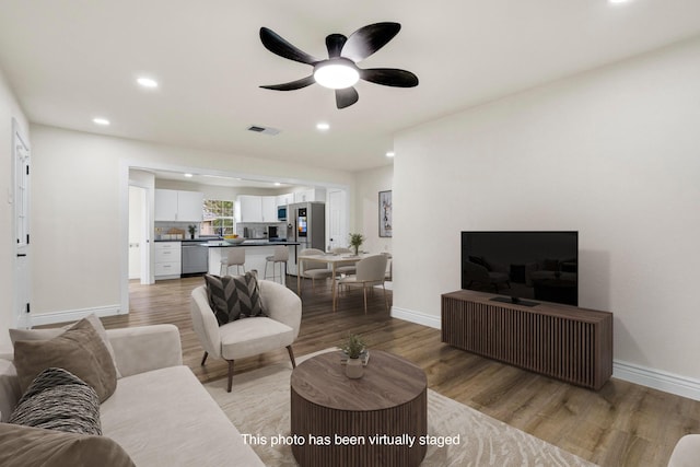 1110 Green St, Abilene, TX 79603 - living room with recessed lighting, light wood-type flooring, baseboards, and a ceiling fan