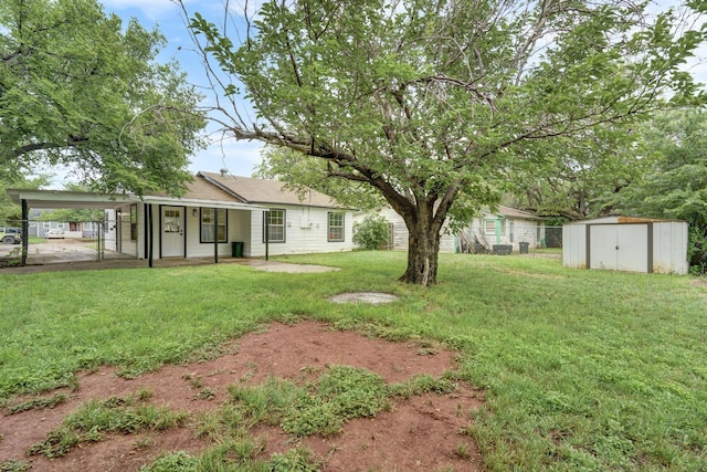 1110 Green St, Abilene, TX 79603 - view of yard featuring a storage unit, an outbuilding, a carport, and a porch