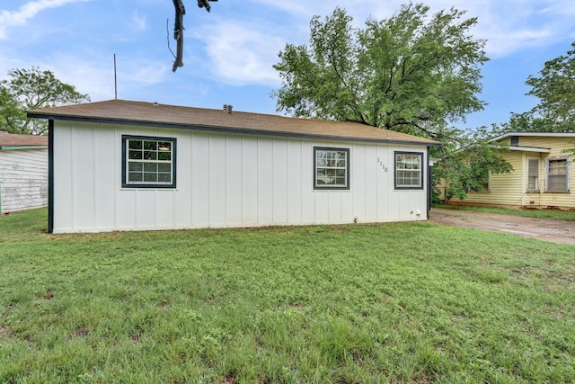 1110 Green St, Abilene, TX 79603 - view of side of home featuring a lawn, board and batten siding, and a shingled roof
