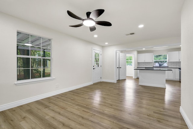 1110 Green St, Abilene, TX 79603 - unfurnished living room featuring light wood-style floors, baseboards, ceiling fan, and recessed lighting