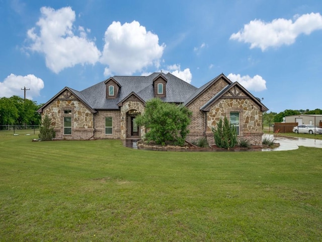 french country home with stone siding and brick siding