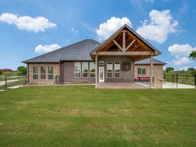back of property featuring a patio area, brick siding, and a shingled roof