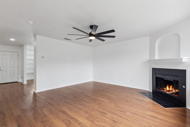 1411 Thistle Cir, Allen, TX 75002 - unfurnished living room featuring a tiled fireplace, ceiling fan, and wood finished floors