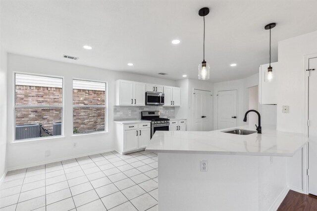 1411 Thistle Cir, Allen, TX 75002 - kitchen featuring stainless steel appliances, a sink, white cabinets, baseboards, and light countertops