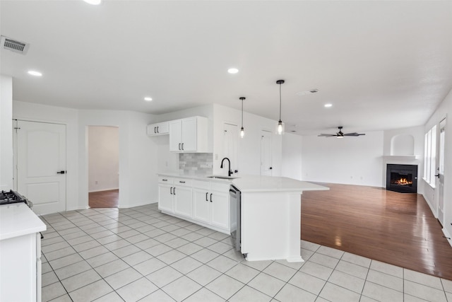 1411 Thistle Cir, Allen, TX 75002 - kitchen with open floor plan, light tile patterned floors, a sink, dishwasher, and light countertops