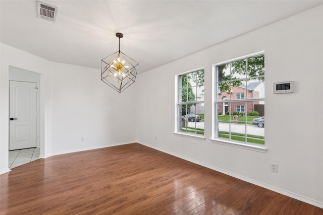 1411 Thistle Cir, Allen, TX 75002 - unfurnished dining area with a chandelier, wood finished floors, and baseboards