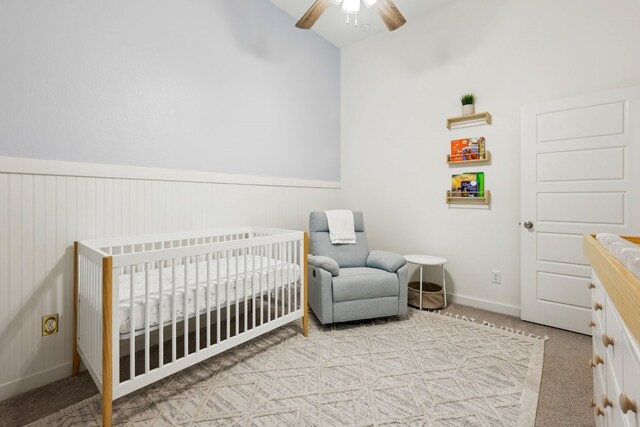 1405 Chickadee Dr, Argyle, TX 76226 - bedroom with carpet, a crib, a ceiling fan, wainscoting, and baseboards