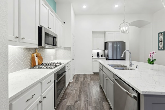 1405 Chickadee Dr, Argyle, TX 76226 - kitchen with appliances with stainless steel finishes, a sink, a kitchen island with sink, dark wood-style floors, and gray cabinets