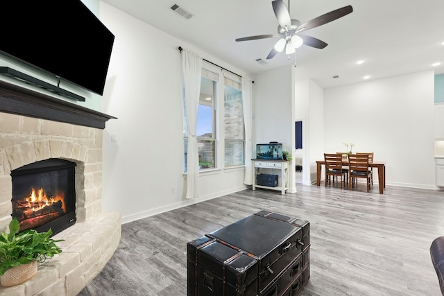 1405 Chickadee Dr, Argyle, TX 76226 - living area featuring a ceiling fan, wood finished floors, a stone fireplace, baseboards, and recessed lighting