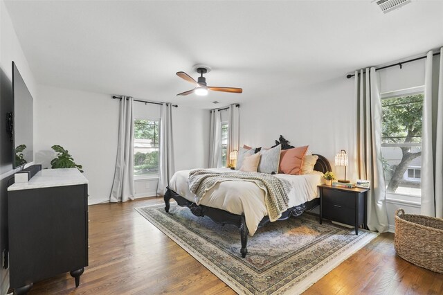 living room featuring attic access, wood finished floors, and baseboards