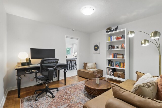 bedroom with wood finished floors, ceiling fan, and baseboards