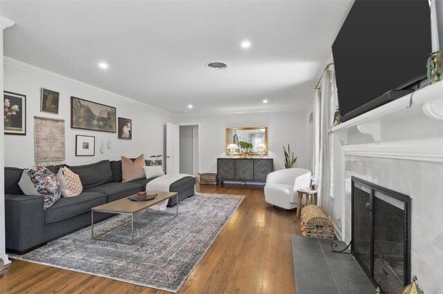 dining space with healthy amount of natural light, wood finished floors, and ornamental molding