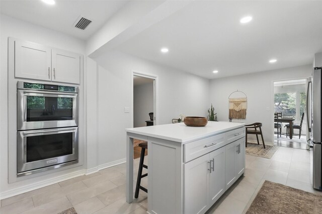 living area with a fireplace, wood finished floors, ornamental molding, and recessed lighting