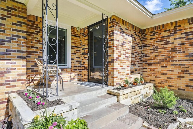 single story home with a chimney, a front yard, and brick siding