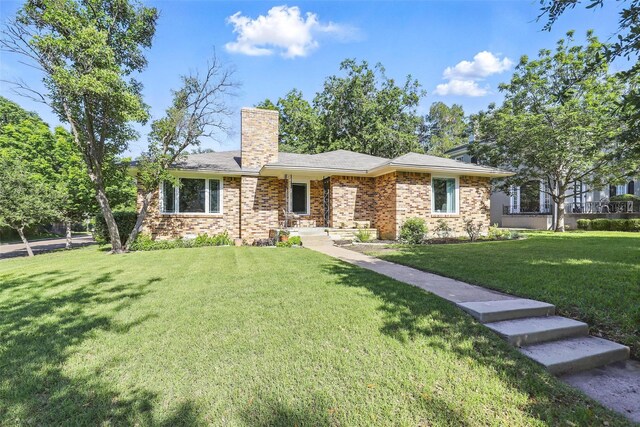 view of front of home featuring concrete driveway, a garage, and a front lawn