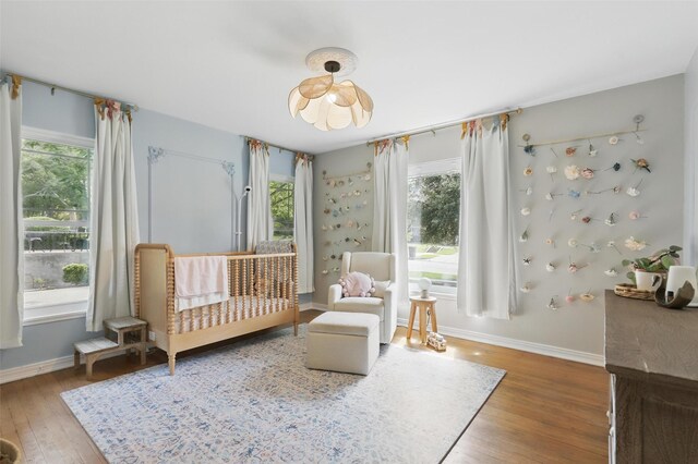 living room featuring ornamental molding, wood finished floors, baseboards, recessed lighting, and a fireplace