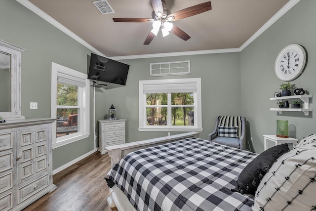 bedroom featuring crown molding, wood finished floors, ceiling fan, and baseboards