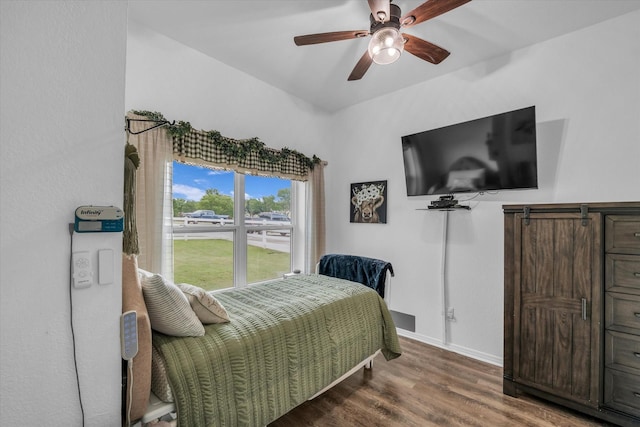 bedroom with wood finished floors, baseboards, and a ceiling fan