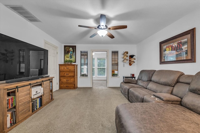 carpeted living room with a ceiling fan