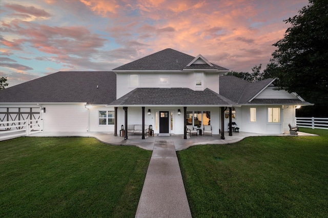 rear view of property with a shingled roof and a porch