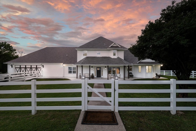 view of front of house featuring covered porch, concrete driveway, a gate, roof with shingles, and a garage