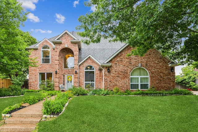 traditional home with brick siding and a shingled roof