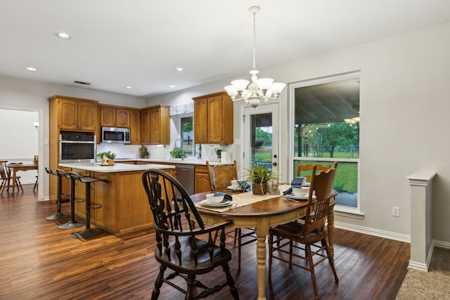dining area with a chandelier, dark wood-style floors, baseboards, and recessed lighting