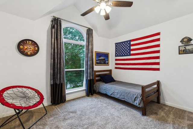 carpeted bedroom featuring multiple windows, vaulted ceiling, baseboards, and a ceiling fan